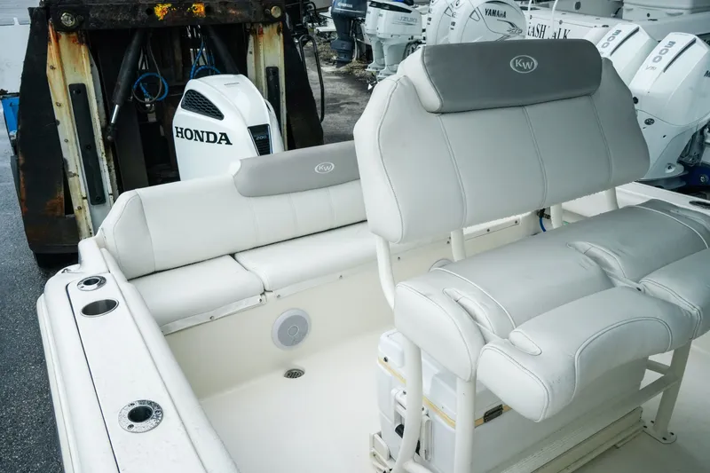 Slide: The Image of 2022 Key West 219 FS boat interior with Honda engine, featuring comfortable seating. - 22