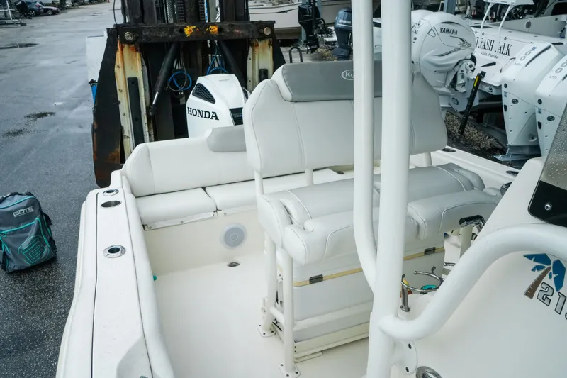 Slide: The Image of 2022 Key West 219 FS boat interior with seating and Honda outboard motor. - 21