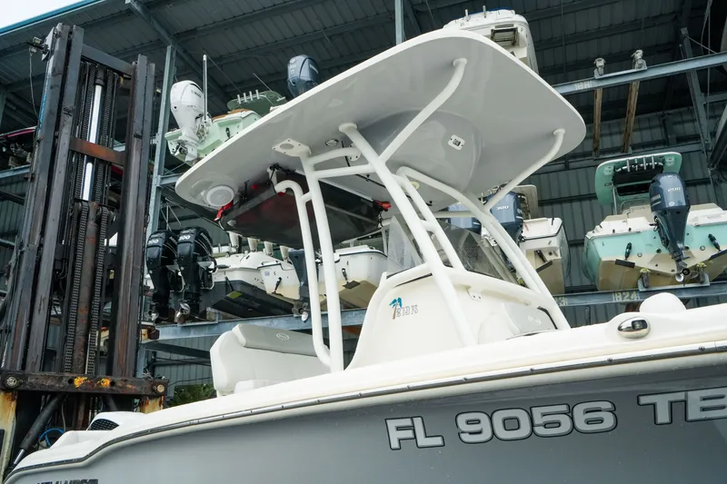 Slide: The Image of 2022 Key West 219 FS boat in storage, surrounded by other boats and equipment. - 50