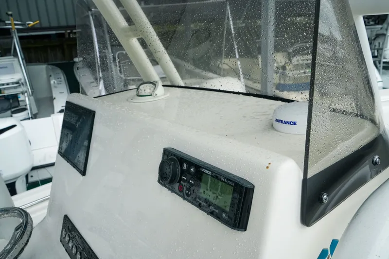 Slide: The Image of 2022 Key West 219 FS boat dashboard with electronics and raindrops. - 30