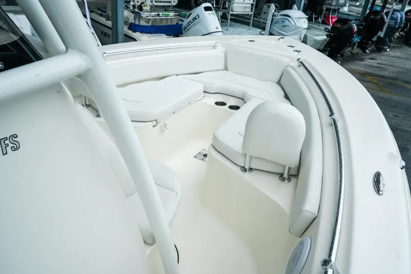 Slide: The Image of 2022 Key West 219 FS boat interior with white seating and cup holders. - 29
