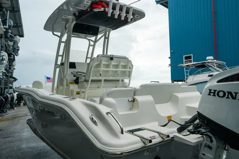 Slide: The Image of 2022 Key West 219 FS boat with Honda engine in marina setting. - 41