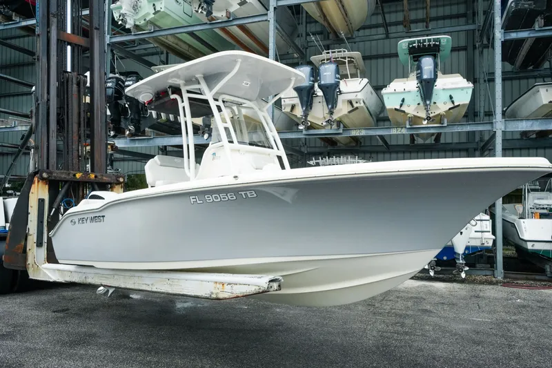 The Image of 2022 Key West 219 FS boat on forklift in storage facility. - 0