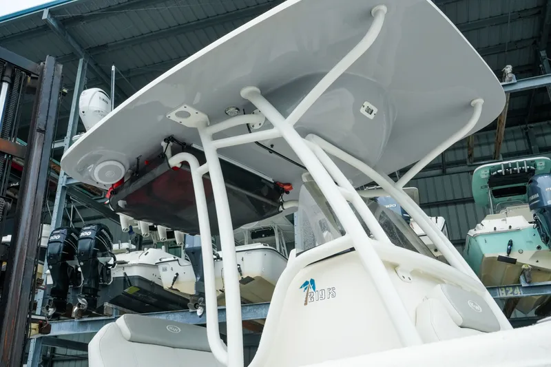 Slide: The Image of 2022 Key West 219 FS boat with T-top in storage facility. - 51