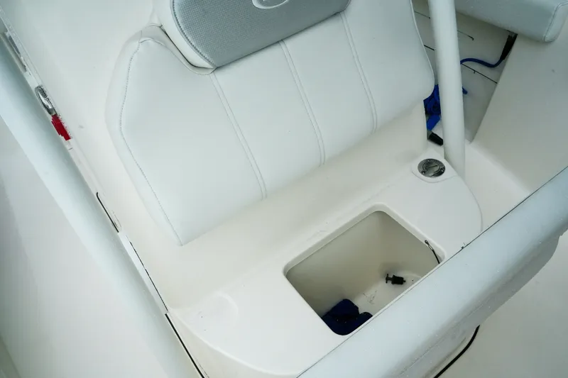 Slide: The Image of 2022 Key West 219 FS boat seat with storage compartment and white upholstery. - 19