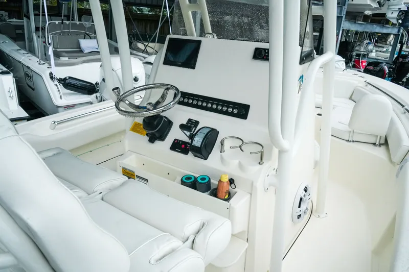 Slide: The Image of 2022 Key West 219 FS boat interior with steering console and seating. - 24