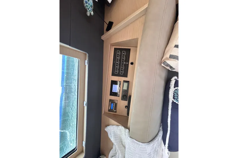 Slide: The Image of Interior view of 2020 Beneteau Oceanis 461 yacht, featuring control panel and window. - 13