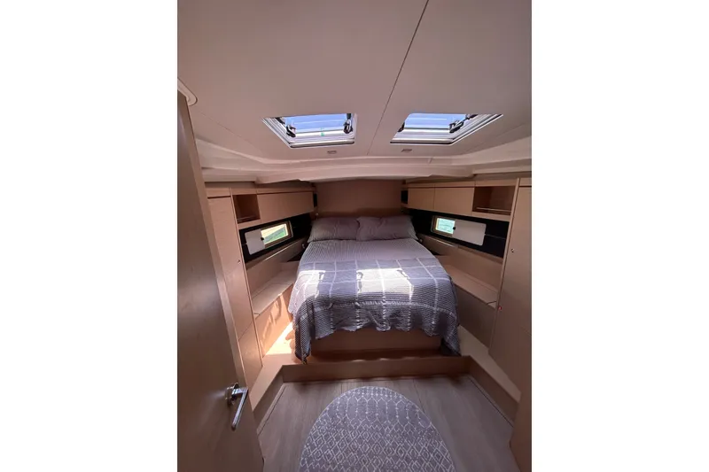 Slide: The Image of Luxurious cabin interior of 2020 Beneteau Oceanis 461 yacht with skylights and cozy bedding. - 15