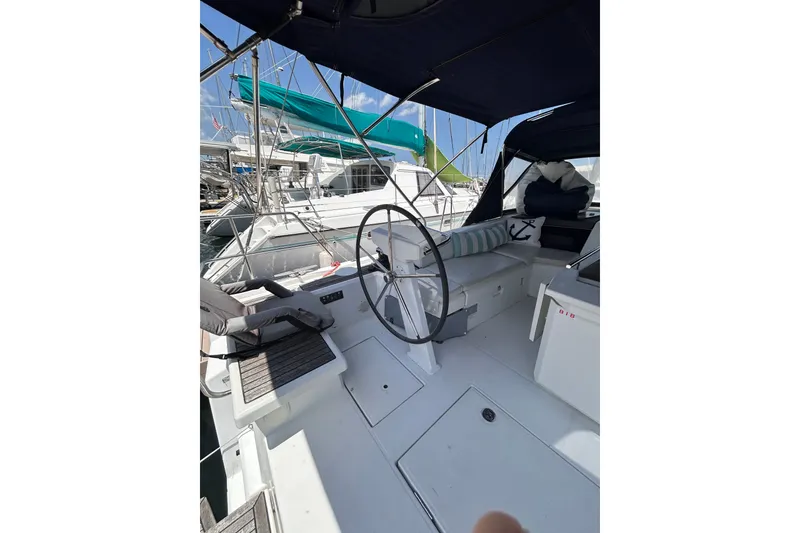 Slide: The Image of Cockpit of 2020 Beneteau Oceanis 461 sailboat with steering wheel and seating area. - 26
