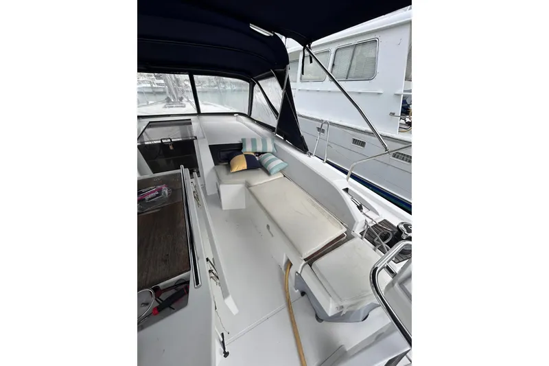 Slide: The Image of Interior view of 2010 Oceanis 46.1 yacht with cushioned seating and canopy. - 2