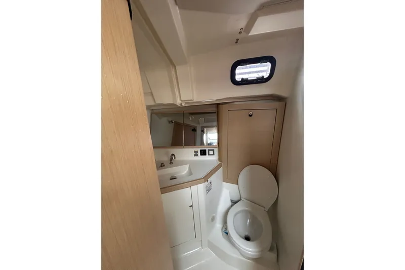 Slide: The Image of Beneteau Oceanis 461 2020 yacht bathroom with sink, toilet, and mirror. - 23