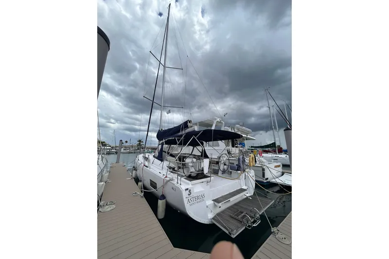 Slide: The Image of Sailboat Oceanis 46.1, 2010 model, docked under cloudy skies at a marina. - 1