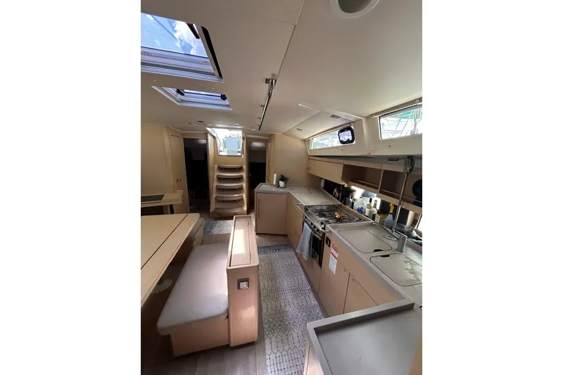 Slide: The Image of Interior of 2020 Beneteau Oceanis 461 yacht, featuring modern kitchen and seating area. - 18