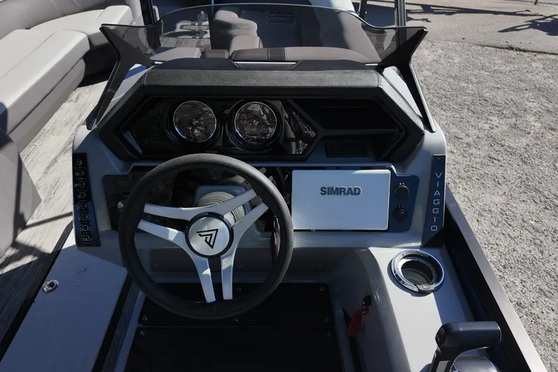 Slide: The Image of 2025 Viaggio Z24Q boat dashboard with steering wheel and Simrad navigation system. - 7