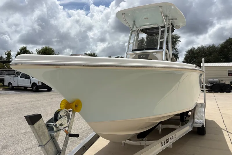 Slide: The Image of 2025 Key West 239 FS boat on trailer under cloudy sky. - 13