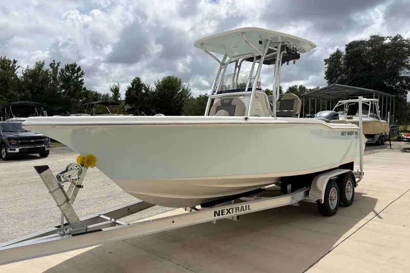 Slide: The Image of 2025 Key West 239 FS boat on trailer under cloudy sky. - 4