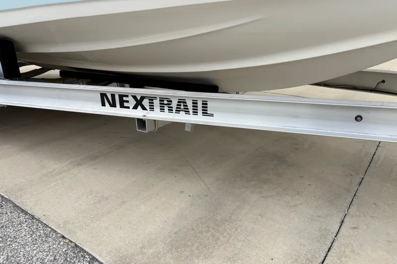 Slide: The Image of 2025 Key West 239 FS boat on NexTrail trailer, parked on concrete surface. - 30