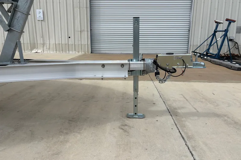 Slide: The Image of Trailer hitch of a 2025 Key West 239 FS boat, parked on concrete. - 29