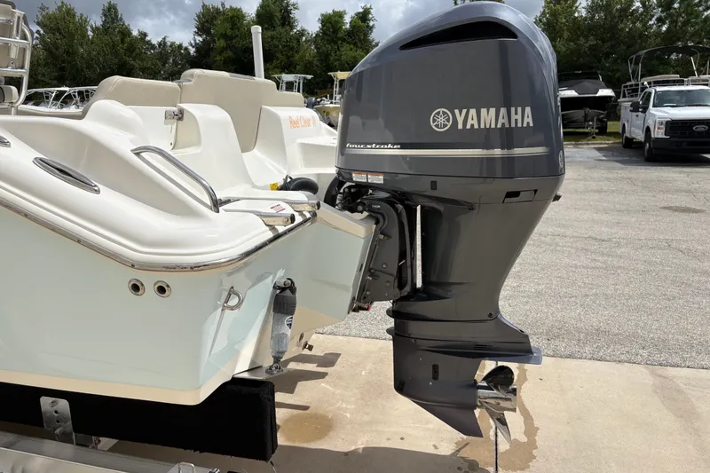 Slide: The Image of 2025 Key West 239 FS boat with Yamaha outboard motor in a marina setting. - 8