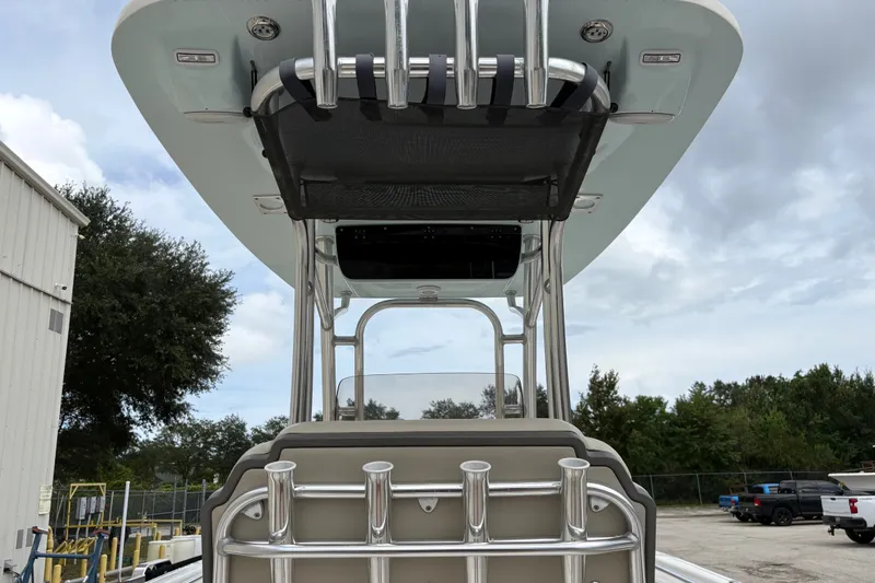 Slide: The Image of 2025 Key West 239 FS boat with T-top and rod holders, parked outdoors. - 26