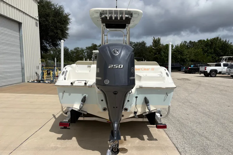 Slide: The Image of 2025 Key West 239 FS boat with Yamaha 250 engine, parked outdoors. - 7