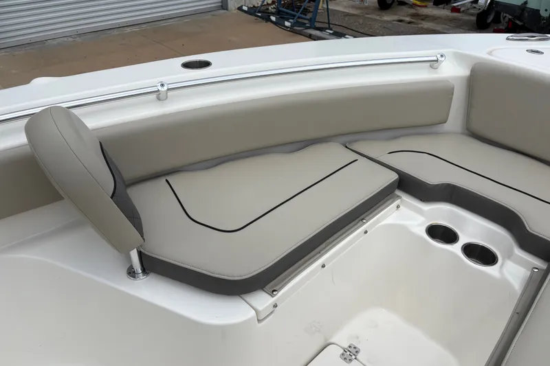 Slide: The Image of 2025 Key West 239 FS boat interior with cushioned seating and cup holders. - 15