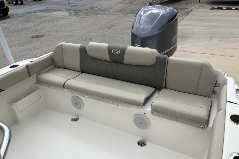 Slide: The Image of 2025 Key West 239 FS boat interior with cushioned seating and Yamaha outboard motor. - 23