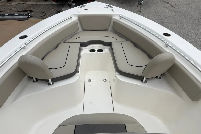 Slide: The Image of 2025 Key West 239 FS boat interior with beige seating and cup holders. - 14