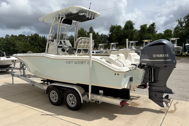 Slide: The Image of 2025 Key West 239 FS boat on trailer with Yamaha outboard motor, parked outdoors. - 6