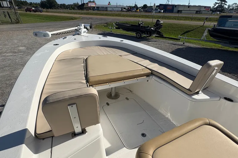 Slide: The Image of 2018 Scout 251 XSS boat interior with beige seating and storage compartments. - 19