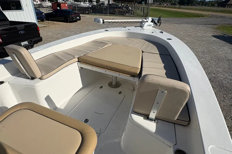 Slide: The Image of 2018 Scout 251 XSS boat interior with beige seating and spacious deck layout. - 18