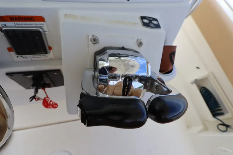 Slide: The Image of Hydra-Sports 4100 VSF 2009 boat throttle controls with warning label and safety features. - 46
