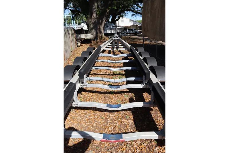 Slide: The Image of Boat trailer for 2009 Hydra-Sports 4100 VSF, parked outdoors on leaf-covered ground. - 64
