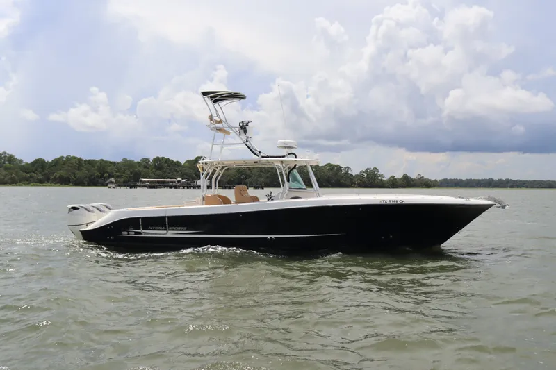 Slide: The Image of 2009 Hydra-Sports 4100 VSF boat cruising on a lake under cloudy skies. - 1