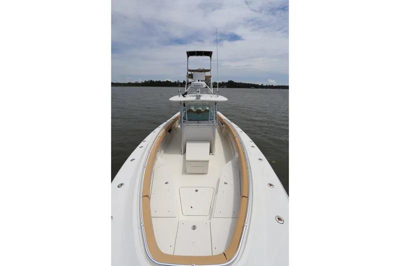 Slide: The Image of 2009 Hydra-Sports 4100 VSF boat on calm water, showcasing spacious deck and helm. - 7
