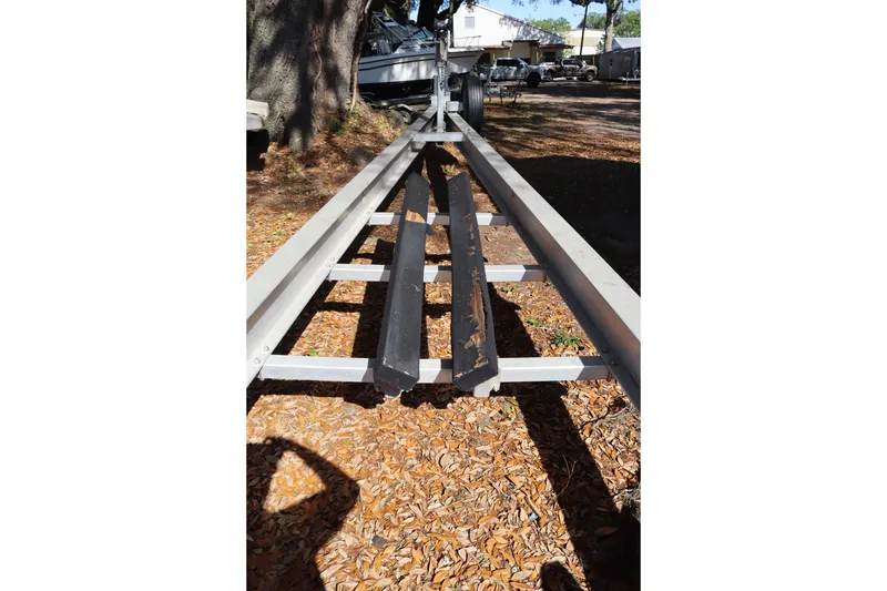Slide: The Image of Boat trailer for 2009 Hydra-Sports 4100 VSF, parked outdoors on leaf-covered ground. - 65