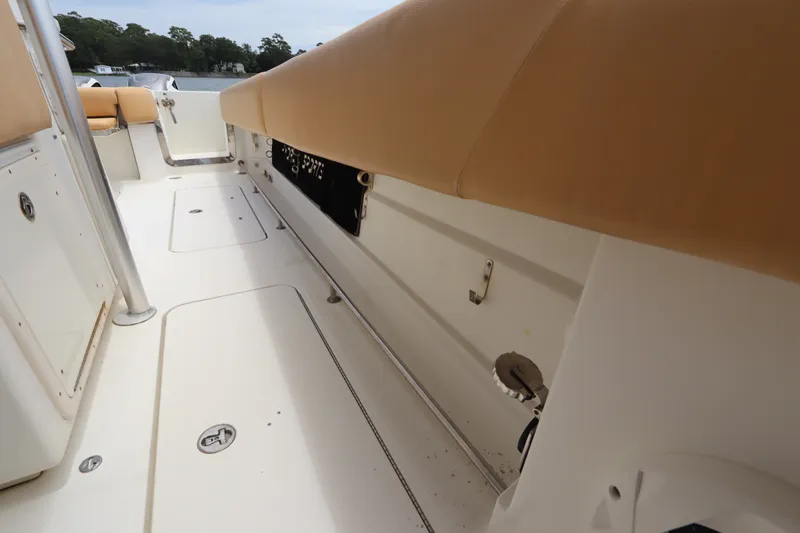 Slide: The Image of 2009 Hydra-Sports 4100 VSF boat interior with tan seating and white deck. - 52