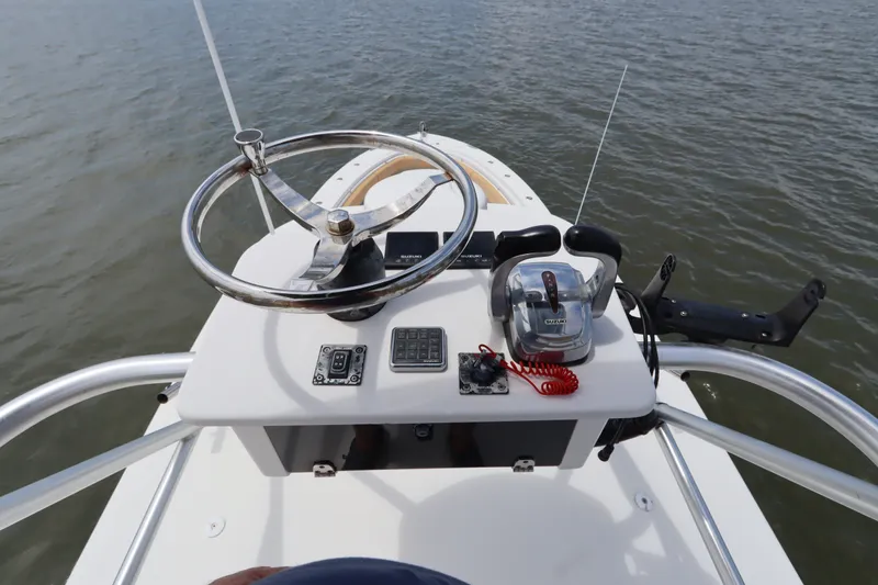 Slide: The Image of 2009 Hydra-Sports 4100 VSF boat helm with steering wheel and controls on water. - 22