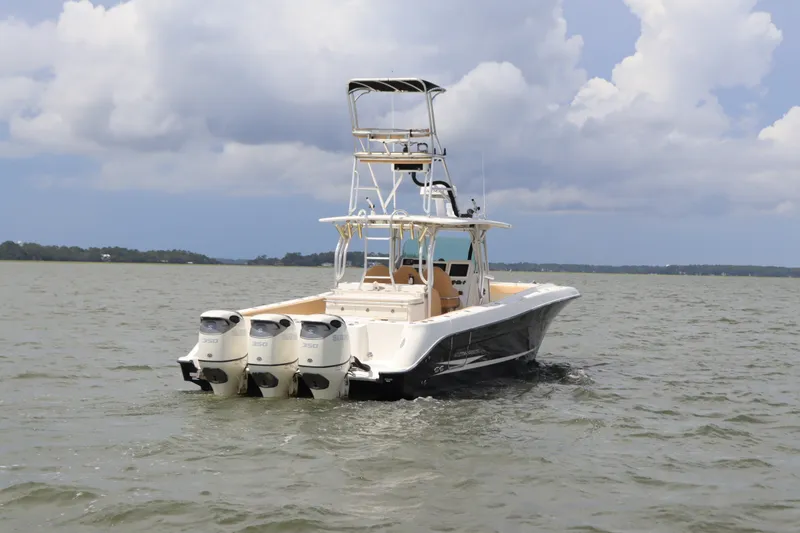 Slide: The Image of 2009 Hydra-Sports 4100 VSF boat with triple engines on open water. - 3