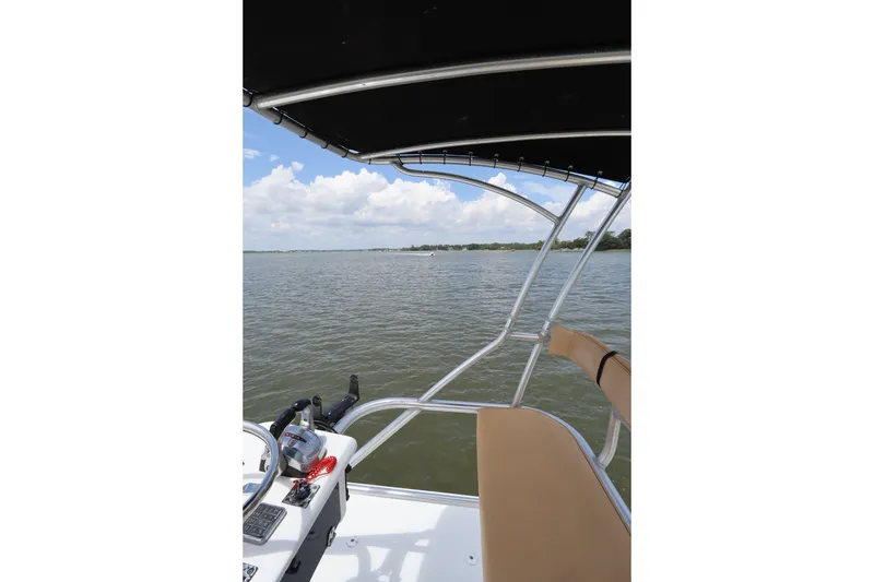 Slide: The Image of 2009 Hydra-Sports 4100 VSF boat on calm water, featuring a sleek design and spacious deck. - 26