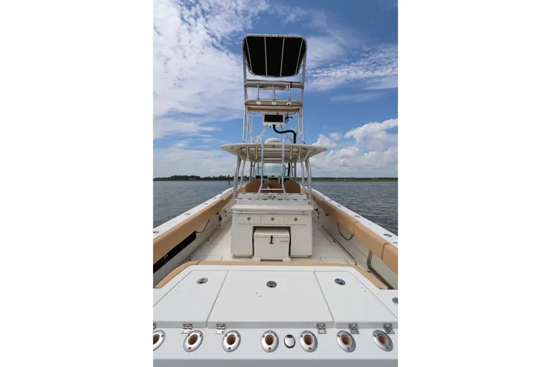 Slide: The Image of 2009 Hydra-Sports 4100 VSF boat on water, featuring spacious deck and tower under blue sky. - 14
