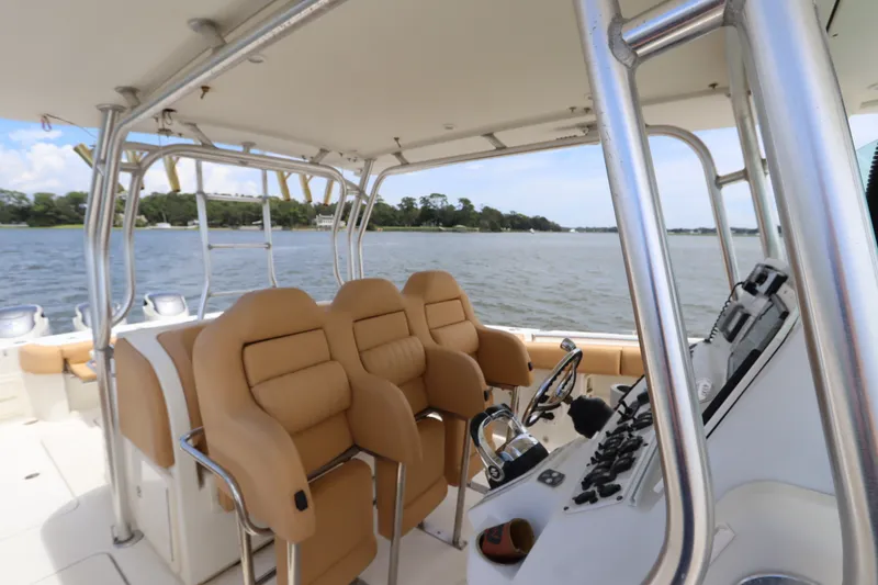 Slide: The Image of 2009 Hydra-Sports 4100 VSF boat interior with tan seating and control panel on a lake. - 29