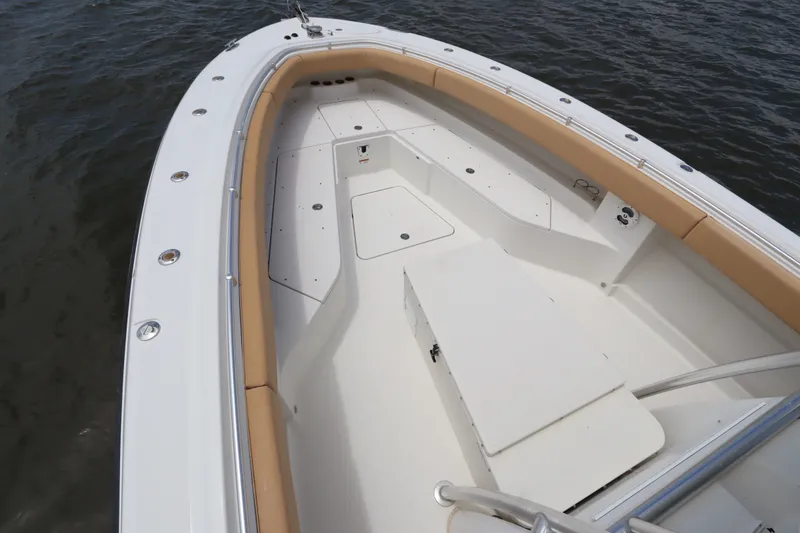 Slide: The Image of 2009 Hydra-Sports 4100 VSF boat deck with tan seating, on calm water. - 5