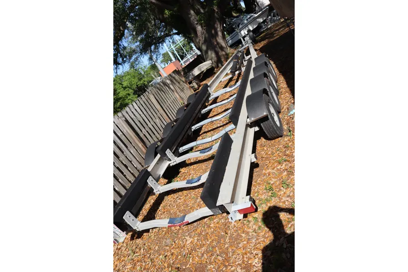 Slide: The Image of Boat trailer for 2009 Hydra-Sports 4100 VSF, parked outdoors on leaf-covered ground. - 63