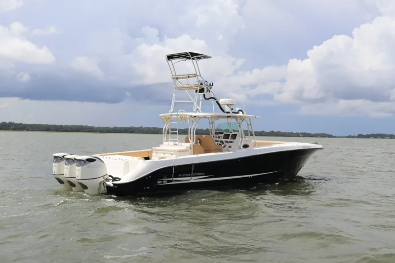 Slide: The Image of 2009 Hydra-Sports 4100 VSF boat on water with triple outboard engines. - 2