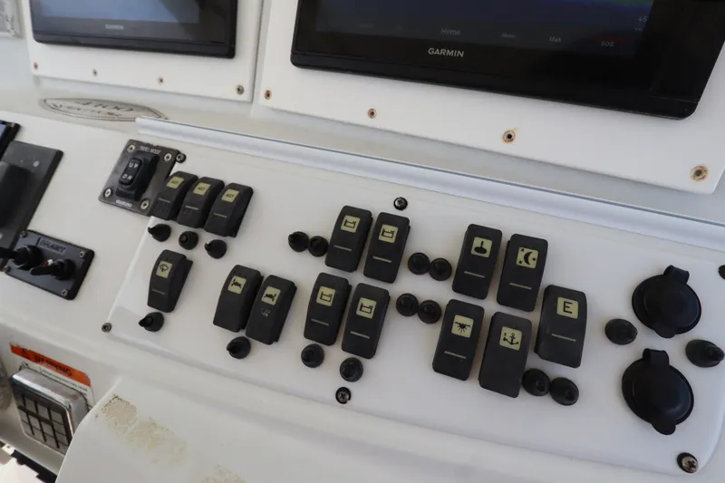 Slide: The Image of Control panel of a 2009 Hydra-Sports 4100 VSF boat with various switches and displays. - 38