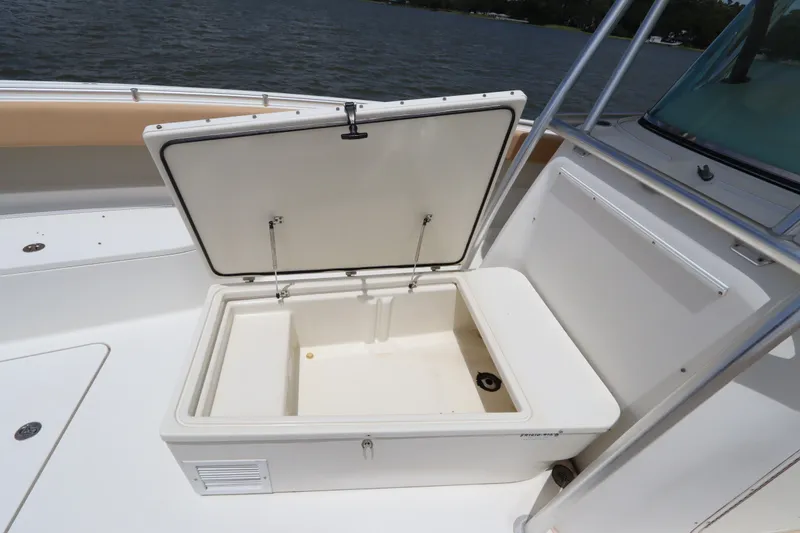 Slide: The Image of Open storage compartment on 2009 Hydra-Sports 4100 VSF boat, near water. - 48