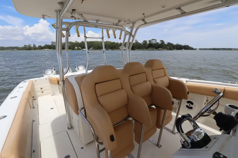 Slide: The Image of 2009 Hydra-Sports 4100 VSF boat interior with tan seating and steering wheel on open water. - 30