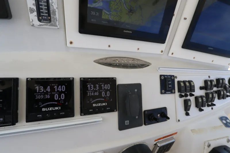 Slide: The Image of Dashboard of a 2009 Hydra-Sports 4100 VSF boat with Suzuki engine displays. - 44