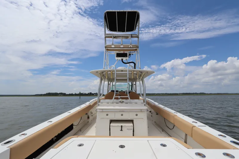 Slide: The Image of 2009 Hydra-Sports 4100 VSF boat on water, featuring spacious deck and tower under blue sky. - 15